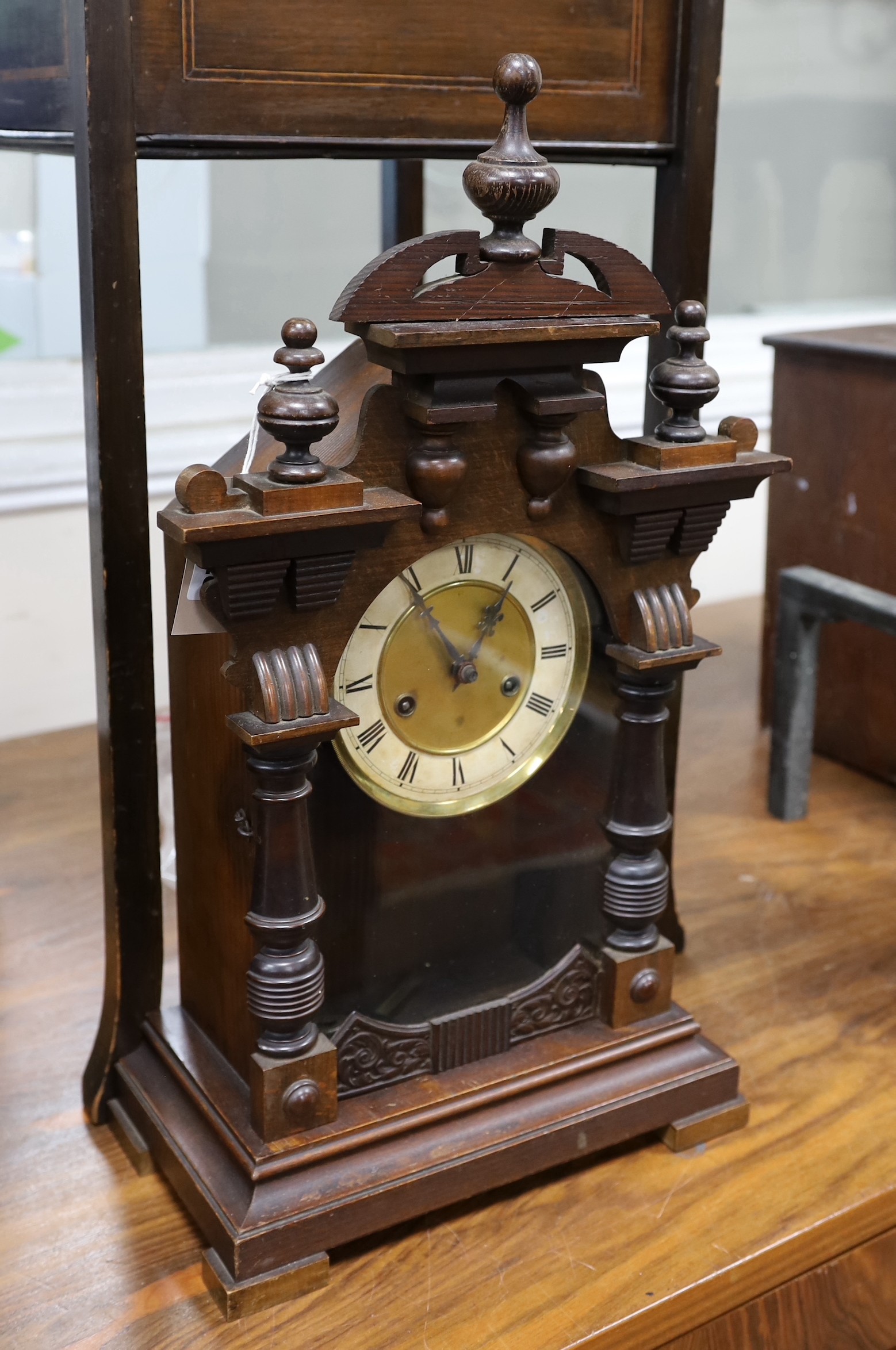 An inlaid mahogany work table, with spring loaded drawer, and a 19th century Black Forest mantel clock